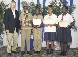  ??  ?? After accepting the champion’s trophy for copping the top spot in the 13-15 age category of the science competitio­n at the Petroleum Corporatio­n of Jamaica’s (PCJ) Schools Energy Programme Awards Ceremony, members of the Half Way Tree Primary School...