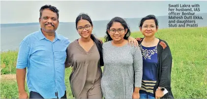  ?? ?? Swati Lakra with her husband, IAS officer Benhur Mahesh Dutt Ekka, and daughters Stuti and Pratiti