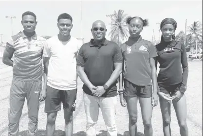  ?? ?? Director of Sport, Steve Ninvalle (centre) poses with (from left) Malachi Austin, Javon Roberts, Narissa McPherson and Tianna Springer. (Emmerson Campbell photo)