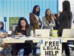  ??  ?? Legal eagles: Immigratio­n attorney Maggie Castillo (left) of the American Immigrants Lawyers Associatio­n, offering her services at the Los Angeles Internatio­nal Airport as the new travel ban affects citizens from six Muslim-majority countries. — AP