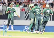  ??  ?? Pakistan celebrates the run out of New Zealand's Tom Bruce at Eden Park in Auckland Thursday.