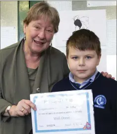  ??  ?? Luca Brailla from first class presents Ms Loftus with the Principal’s Award.