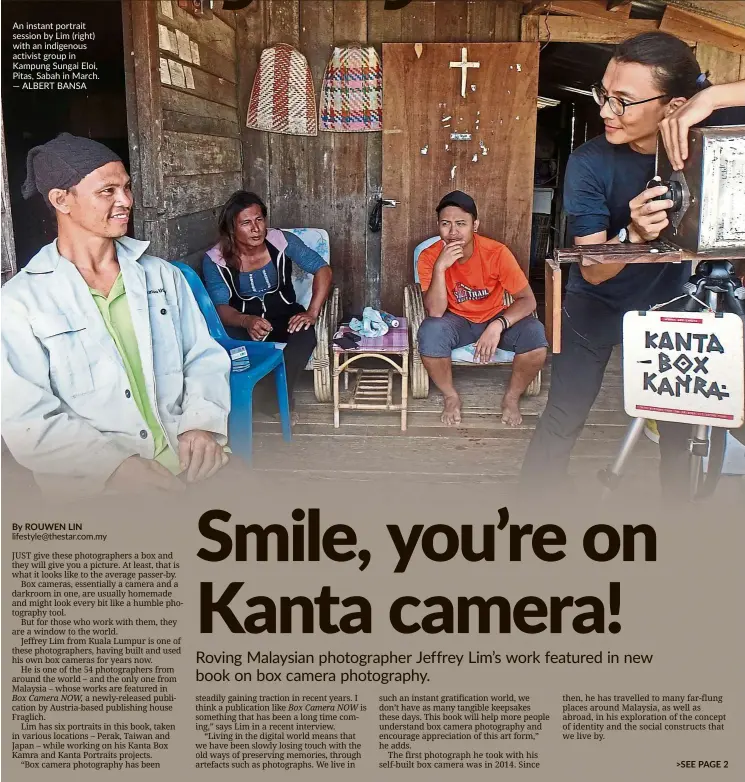  ?? — ALBERT BANSA ?? An instant portrait session by Lim (right) with an indigenous activist group in Kampung Sungai Eloi, Pitas, Sabah in March.