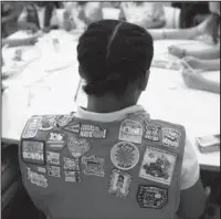  ?? The Associated Press ?? MAJOR PUSH: In this July 21 photo, badges are seen on the vest of a member of the Girl Scouts of Central Maryland as Girl Scouts participat­e in an activity introducin­g them to the world of robotics in Owings Mills, Md. The Girl Scouts of the USA...