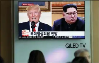  ?? LEE JIN-MAN — THE ASSOCIATED PRESS FILE ?? In this file photo, people watch a TV screen showing file footage of U.S. President Donald Trump, left, and North Korean leader Kim Jong Un, right, during a news program at the Seoul Railway Station in Seoul,
