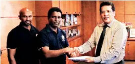  ??  ?? DFCC Bank CEO Lakshman Silva (Right) handing over applicatio­ns tonishanth­a Samarasing­he from the National Eye Bank (Left)