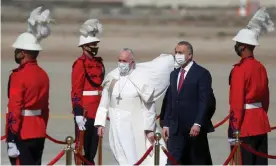  ?? Photograph: Yara Nardi/Reuters ?? Pope Francis is received by the Iraqi prime minister, Mustafa al-Kadhimi, upon disembarki­ng from his plane in Baghdad on Friday.