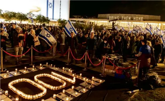  ?? MARCO LONGARI/AFP VIA GETTY IMAGES ?? Antiwar protesters in Tel Aviv lit candles during a demonstrat­ion Saturday marking nearly 100 days of the Israel-Hamas war.