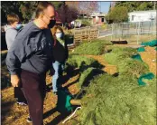  ?? RICH FREEDMAN — TIMES-HERALD ?? John, Kathy and Peter Hurst came over from Benicia to seek a Christmas Tree at Loma Vista Farm.