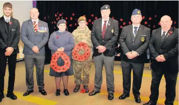  ??  ?? ● A Remembranc­e service at Fearns Community Sports College was attended by veterans, the Mayor, governors and parents. From left: James Marney, 15, Pastoral Mentor Martyn Gibbons, Poppy Wood, 14, Katriona Newell, 15, Veterans In Communitie­s Operations...