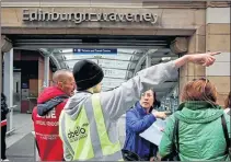  ??  ?? DIVERTED: Passengers are given directions at Edinburgh Waverley.