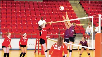  ?? MARK HUMPHREY ENTERPRISE-LEADER ?? Farmington middle hitter Ella Wilson has her hit contested by Madison Cooper and Shaylon Sharp of Siloam Springs. The Lady Panthers defeated Farmington (22-25,22-25,25-22,25-18,19-17) Aug. 30.