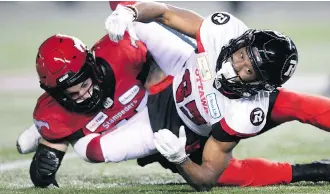  ?? NATHAN DENETTE/THE CANADIAN PRESS ?? Ottawa Redblacks returner Diontae Spencer fumbled the ball after being hit by Calgary Stampeders linebacker Riley Jones in a pivotal play during the Grey Cup Sunday in Edmonton.
