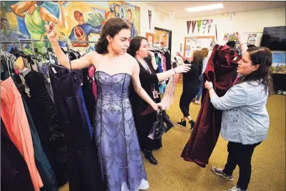  ?? Hearst Connecticu­t Media file photo ?? Stamford High’s Claudia Moses looks at various prom dresses and accessorie­s with the help of Shana Yakubovich during the sixth annual Cinderella Project at Stamford High School on March 28, 2019. Students were able to browse some 300 items that included brand-new and gently used prom gowns, graduation dresses, tuxedos, special occasion shoes and jewelry.