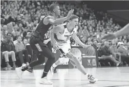  ??  ?? Virginia s guard Kyle Guy (5) dribbles the ball past Virginia Commonweal­th guard Malik Crowfield (13).