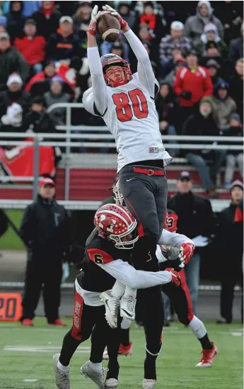  ??  ?? Palatine’s Johnny O’Shea leaps to make a catch Saturday against Maine South in a Class 8A semifinal in Park Ridge. The Hawks prevailed 28- 14 and will play Loyola for the state title.
| MARK WELSH/ DAILY HERALD