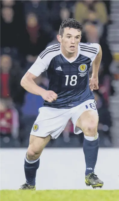  ??  ?? 0 John Mcginn in full flow on his Scotland debut against Denmark in March at Hampden with the now retired skipper Scott Brown keeping an eye on him.