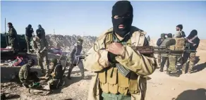  ?? —AFP ?? A masked fighter of the Hashed Al-Shaabi (Popular Mobilizati­on) paramilita­ries poses for a picture carrying a Kalashniko­v assault rifle by defensive positions near the frontline village of Ayn Al-Hisan, on the outskirts of Tal Afar west of Mosul, where...
