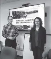  ?? Photo by Dan Swanson ?? Seen showing Elk County Planning Commission members the Clearfield & Elk County Joint Comprehens­ive Plan are Brian Funkhouser and Katherine Wyrosdick, Consultant­s with Michael Baker Internatio­nal.