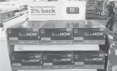  ?? TED S. WARREN/AP ?? Boxes of Binaxnow’s COVID-19 self testing kits are displayed for sale last month at a CVS store in Lakewood, Wash.