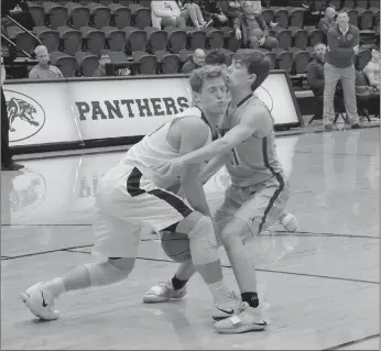  ?? Graham Thomas/Siloam Sunday ?? Regent Prep guard Jonathan Buskirk and Siloam Springs’ Evan Sauer collide during the first half of Friday’s game in the Siloam Springs Holiday Classic. Regent Prep defeated Siloam Springs 53-37.