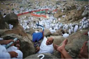  ?? (Reuters) ?? MUSLIM PILGRIMS gather on Mount Mercy on the plains of Arafat outside Mecca yesterday during the annual pilgrimage.