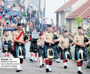  ??  ?? Parade The Balaklava Pipe and Drums led the crowd through the village