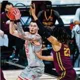  ?? MICHAEL CONROY / AP ?? Ohio State forward
Kyle Young (left) looks to shoot over Minnesota forward Brandon Johnson back on March 11 in the Big Ten Conference tournament. He missed Friday’s NCAA tourney game because of a concussion.