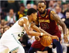  ?? — AFP photo ?? Marcus Smart (left) of the Boston Celtics is defended by Cavaliers’ LeBron James during the second quarter in Game One of the Eastern Conference Finals of the 2018 NBA Playoffs at TD Garden in Boston, Massachuse­tts.