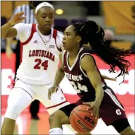  ?? (Photo courtesy UALR Athletics) ?? UALR’s Mayra Caicedo (right) drives around Louisiana-Lafayette’s Jomyra Mathis during Sunday’s Sun Belt Conference Tournament semifinal in Pensacola, Fla. Caicedo had 11 points and six assists for the Trojans, who lost 58-48.
