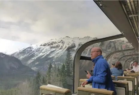  ?? JENNIFER ALLFORD FOR THE TORONTO STAR ?? Passengers on board the Rocky Mountainee­r keep a keen eye out hoping to spot a bear and other wildlife in the Rocky Mountains.