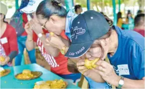  ?? ?? Manggahan Festival of Guimaras Island this year will still be a pared down celebratio­n due to the coronaviru­s disease 2019 pandemic. This file photo shows people eating Guimaras’ sweet mangoes in the so-called “eat all you can” festival event.