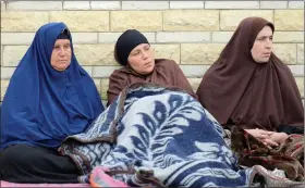  ?? REUTERS ?? Relatives of victims of the explosion at Al-Rawda mosque, sit outside Suez Canal University hospital in Ismailia, Egypt, on 25 November.
