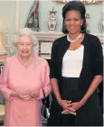  ??  ?? Elegant style: Michelle Obama wearing a cardigan with the Queen