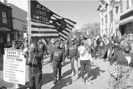  ?? BRIAN KRISTA/BALTIMORE SUN MEDIA PHOTOS ?? Supporters of the 1,000 Men March make their way down Main Street in Annapolis on Saturday.