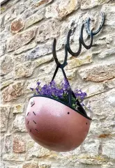  ??  ?? An old helmet can have a second life as an equestrian-themed hanging basket