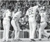  ?? DAVID J. PHILLIP/AP ?? The Cubs’ Miguel Montero, right, is greeted after his grand slam to right field made the score 7-3.