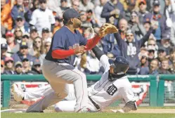  ?? CARLOS OSORIO/THE ASSOCIATED PRESS ?? The Tigers’ Nicholas Castellano­s, right, slides safely into third as Red Sox third baseman Pablo Sandoval waits on the throw Friday in Detroit. The Tigers won 6-3.