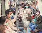 ??  ?? Passengers on the public metro in Taipei, Taiwan, wear face masks to help curb the spread of the coronaviru­s.
