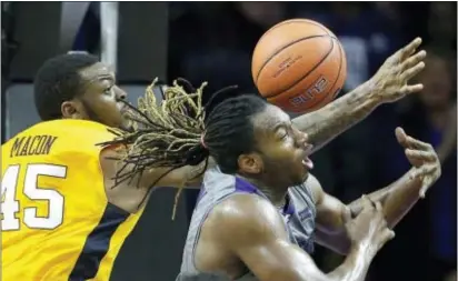  ?? CHARLIE RIEDEL — THE ASSOCIATED PRESS ?? Kansas State’s D.J. Johnson, right, and West Virginia’s Elijah Macon (45) battle for a rebound during second half of a game Saturday in Manhattan, Kan. West Virginia won 87-83 in double overtime.
the