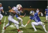  ?? COLEEN MOSKOWITZ — THE NEWS-HERALD ?? Perry’s DeAndre Malone looks for a stiff-arm in front of Madison’s Jonas Pinta on Sept. 7. The Pirates won, 38-6.