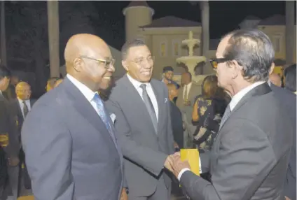  ?? ?? Businessma­n Joe Bogdanovic­h (right) greets Prime Minister Andrew Holness (centre) while tourism minister and Member of Parliament for St James East Central Edmund Bartlett looks on during a fundraisin­g dinner to commemorat­e the 25th anniversar­y of Bartlett’s East Central St James Education Fund at the Half Moon Hotel Conference Centre in Montego Bay last week.