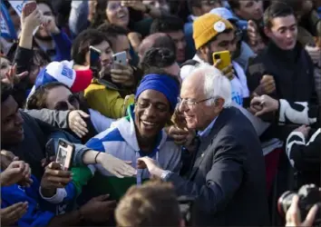  ?? Eduardo Munoz Alvarez/Associated Press ?? Democratic presidenti­al candidate Sen. Bernie Sanders, I-Vt., greets supporters at the end of his rally Saturday in New York.