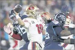  ?? WADE PAYNE — THE ASSOCIATED PRESS ?? San Francisco 49ers quarterbac­k Jimmy Garoppolo throws as he is pressured by Tennessee Titans defenders in the second half of their Dec. 23 game in Nashville, Tennessee. Garoppolo turned out another dud in the Niners’ 20-17 loss to the Titans.