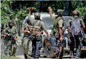  ?? — PTI ?? Army soldiers in action during an encounter outside a house where militants were hiding in Shopian district of south Kashmir on Sunday.