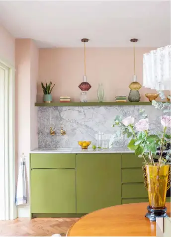  ??  ?? KITCHEN The marble splashback injects a hit of welcome drama to the soft ice-cream scheme. SMALL BUT PERFECT A slim, floor-to-ceiling cabinet tucked into an alcove makes great use of space and is used to store crockery (below).