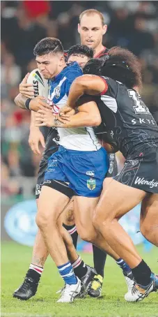  ?? Picture: AAP Image ?? The Bulldogs’ Brad Abbey is stopped by Warriors defender Bunty Afoa in Dunedin.