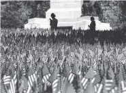  ?? THE ASSOCIATED PRESS ?? People view flags Thursday on Boston Common placed there for Memorial Day.