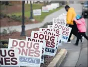  ?? Joe Raedle Getty Images ?? DEMOCRAT DOUG JONES is favored by younger residents of Alabama, surveys show. But do they vote? A turnout of 25% is expected in Tuesday’s election.