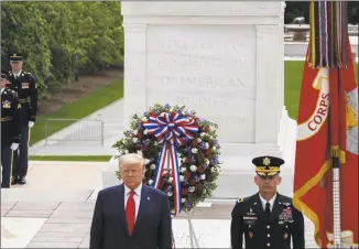  ?? Alex Brandon / Associated Press ?? President Donald Trump stands after placing a wreath at the Tomb of the Unknown Soldier in Arlington National Cemetery in honor of Memorial Day on Monday.
